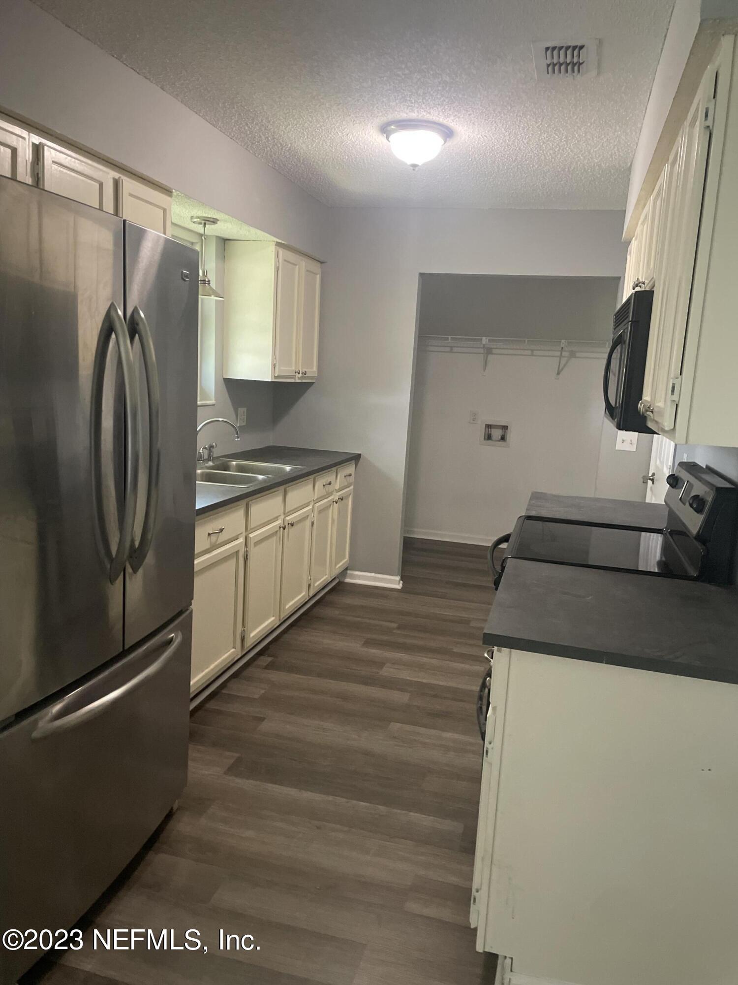 7952 Gulf Road South Jacksonville, FL 32244 - Photo 4 of 14 a kitchen with stainless steel appliances granite countertop a refrigerator and a stove