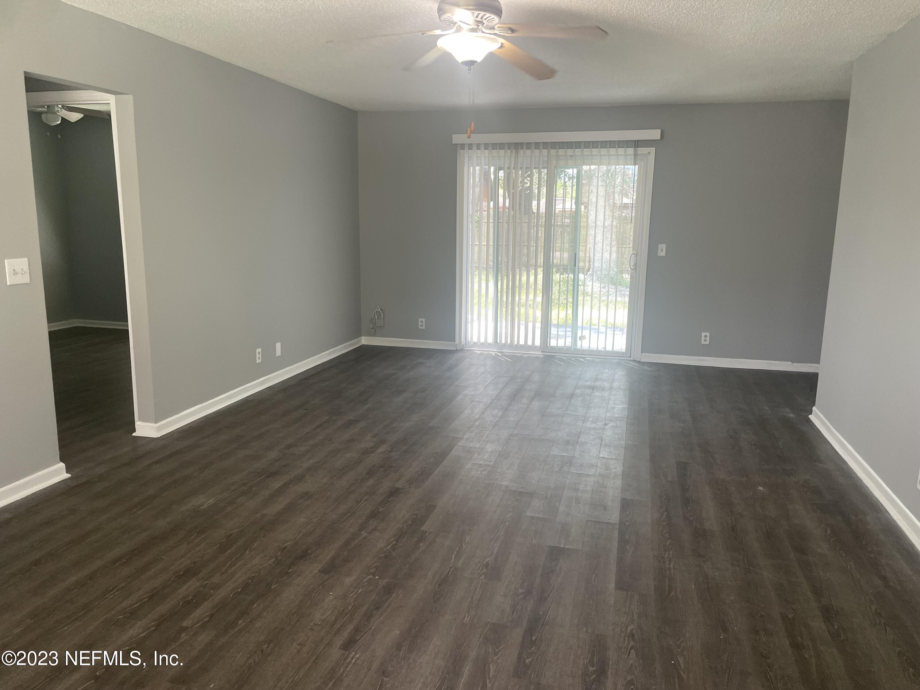 7952 Gulf Road South Jacksonville, FL 32244 - Photo 5 of 14 a view of an empty room with wooden floor and a window