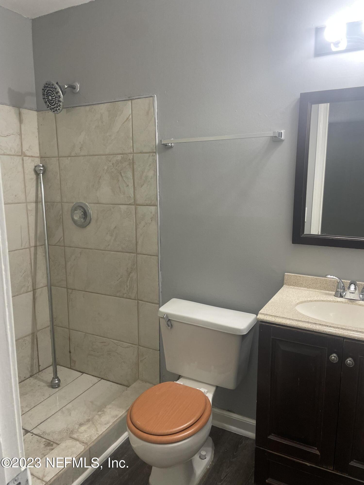 7952 Gulf Road South Jacksonville, FL 32244 - Photo 9 of 14 a white toilet sitting next to a bathroom sink