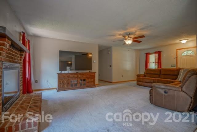 9675 Mt Olive Road Mount Pleasant, NC 28124 - Photo 12 of 48 a living room with furniture and a flat screen tv