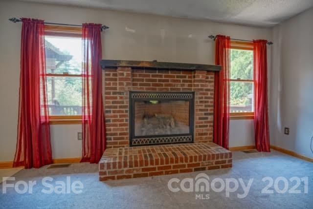 9675 Mt Olive Road Mount Pleasant, NC 28124 - Photo 16 of 48 a living room with a fireplace and a window