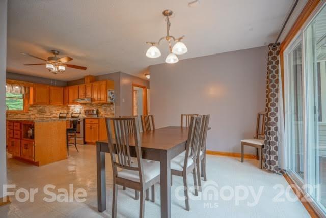 9675 Mt Olive Road Mount Pleasant, NC 28124 - Photo 19 of 48 a view of a dining room with furniture and chandelier