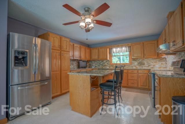 9675 Mt Olive Road Mount Pleasant, NC 28124 - Photo 22 of 48 a kitchen with refrigerator cabinets and a sink