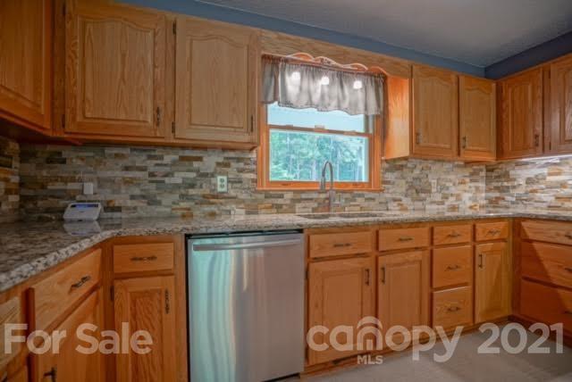 9675 Mt Olive Road Mount Pleasant, NC 28124 - Photo 23 of 48 a kitchen with stainless steel appliances granite countertop a sink stove and cabinets