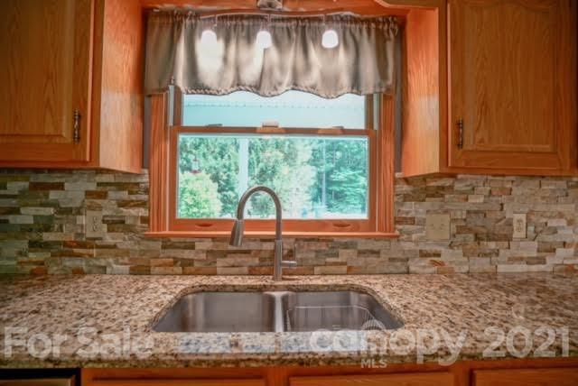9675 Mt Olive Road Mount Pleasant, NC 28124 - Photo 24 of 48 a kitchen with granite countertop a sink and a window