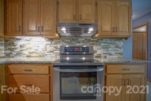 9675 Mt Olive Road Mount Pleasant, NC 28124 - Photo 25 of 48 a stove top oven sitting inside of a kitchen
