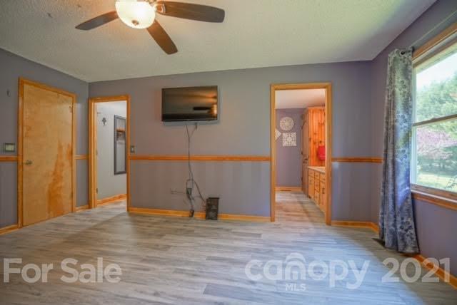 9675 Mt Olive Road Mount Pleasant, NC 28124 - Photo 30 of 48 a view of a livingroom with wooden floor and a ceiling fan