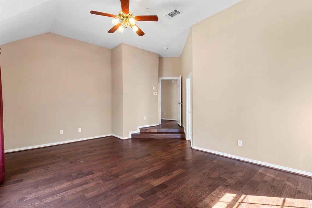 14588 Poe Court Addison, TX 75001 - Photo 23 of 28 a view of an empty room with wooden floor