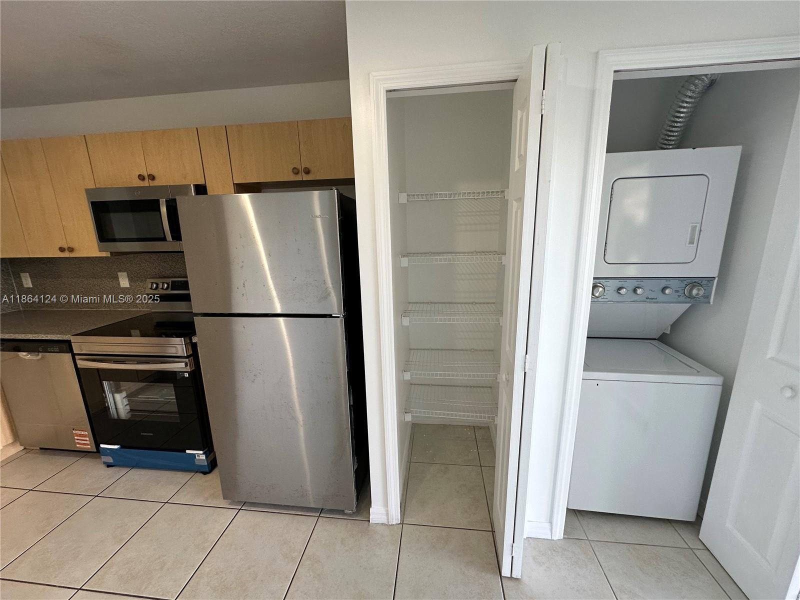 2910 Southeast 13th Avenue, Unit 10250 Homestead, FL 33035 - Photo 11 of 23 a kitchen with stainless steel appliances granite countertop a refrigerator and a stove top oven