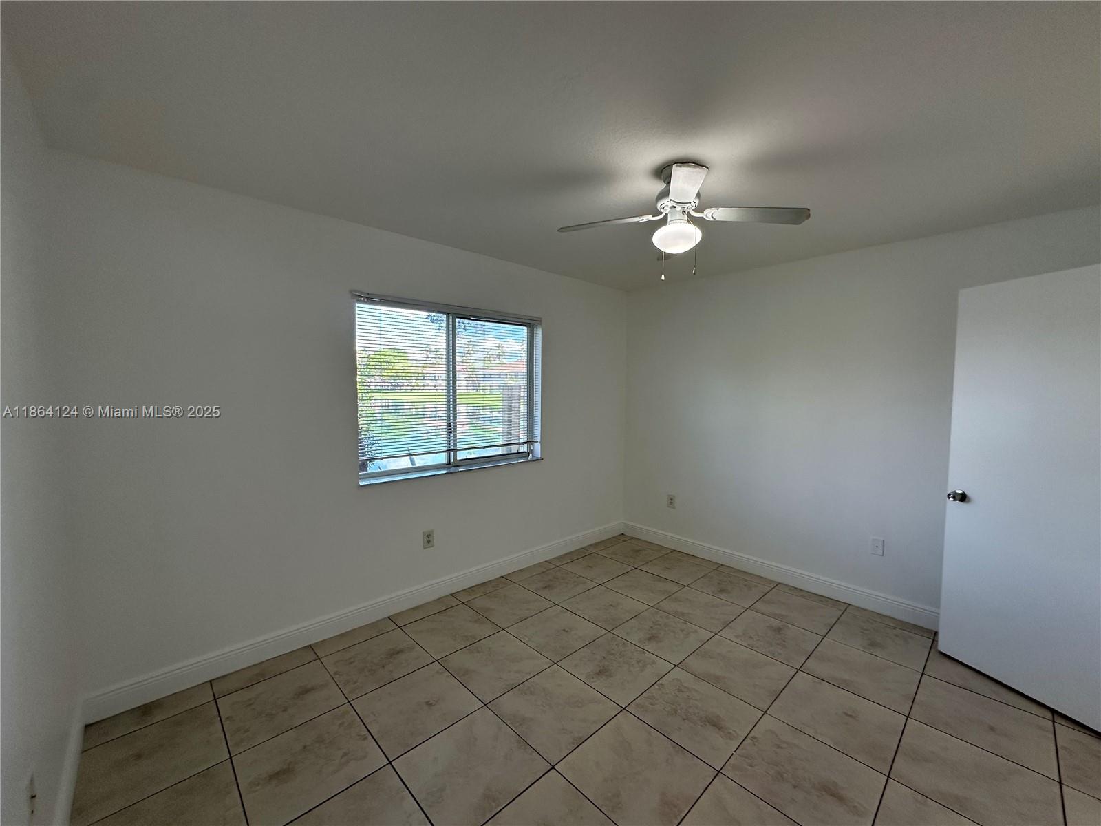 2910 Southeast 13th Avenue, Unit 10250 Homestead, FL 33035 - Photo 15 of 23 an empty room with windows and fan