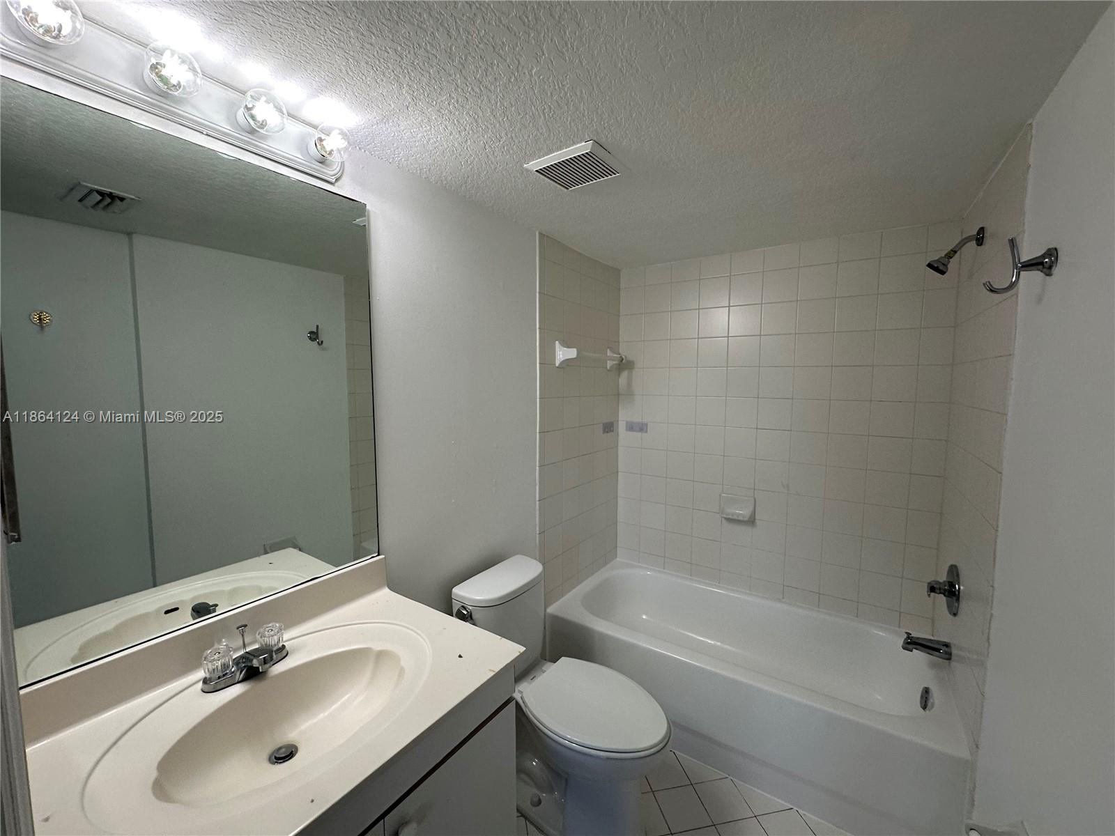 2910 Southeast 13th Avenue, Unit 10250 Homestead, FL 33035 - Photo 17 of 23 a bathroom with a sink toilet and shower
