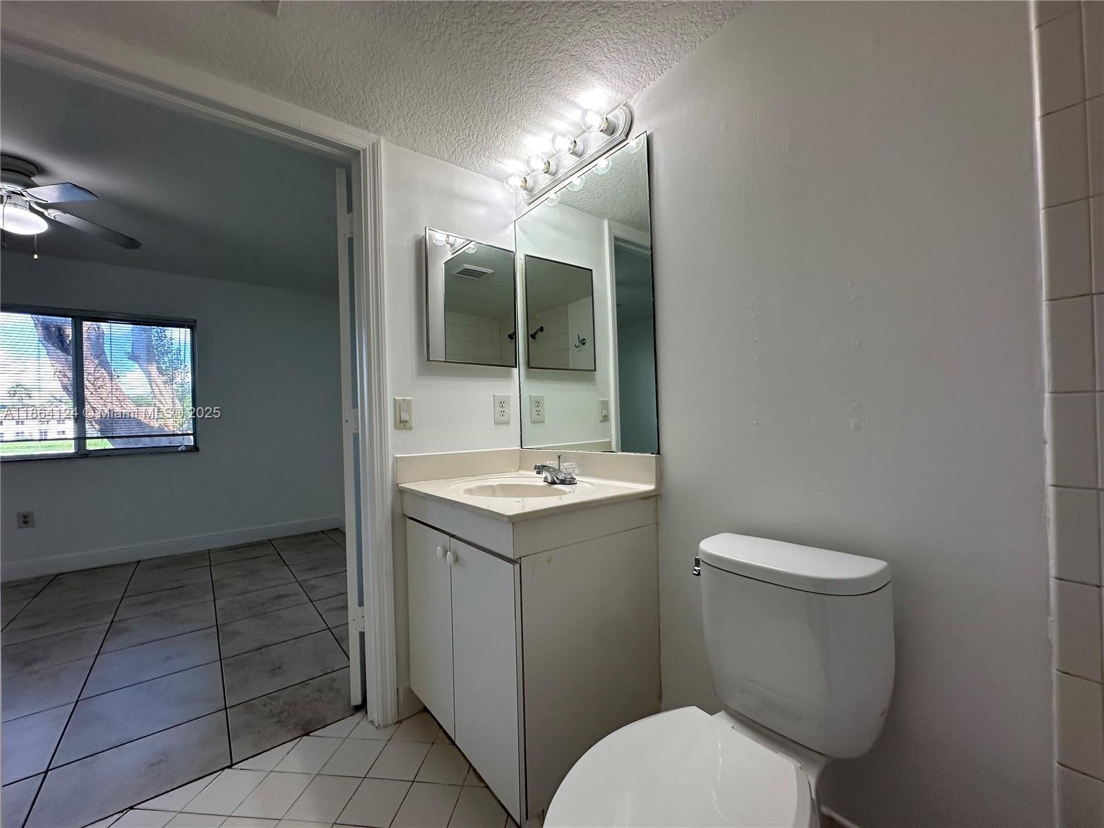 2910 Southeast 13th Avenue, Unit 10250 Homestead, FL 33035 - Photo 19 of 23 a bathroom with a sink a toilet and mirror