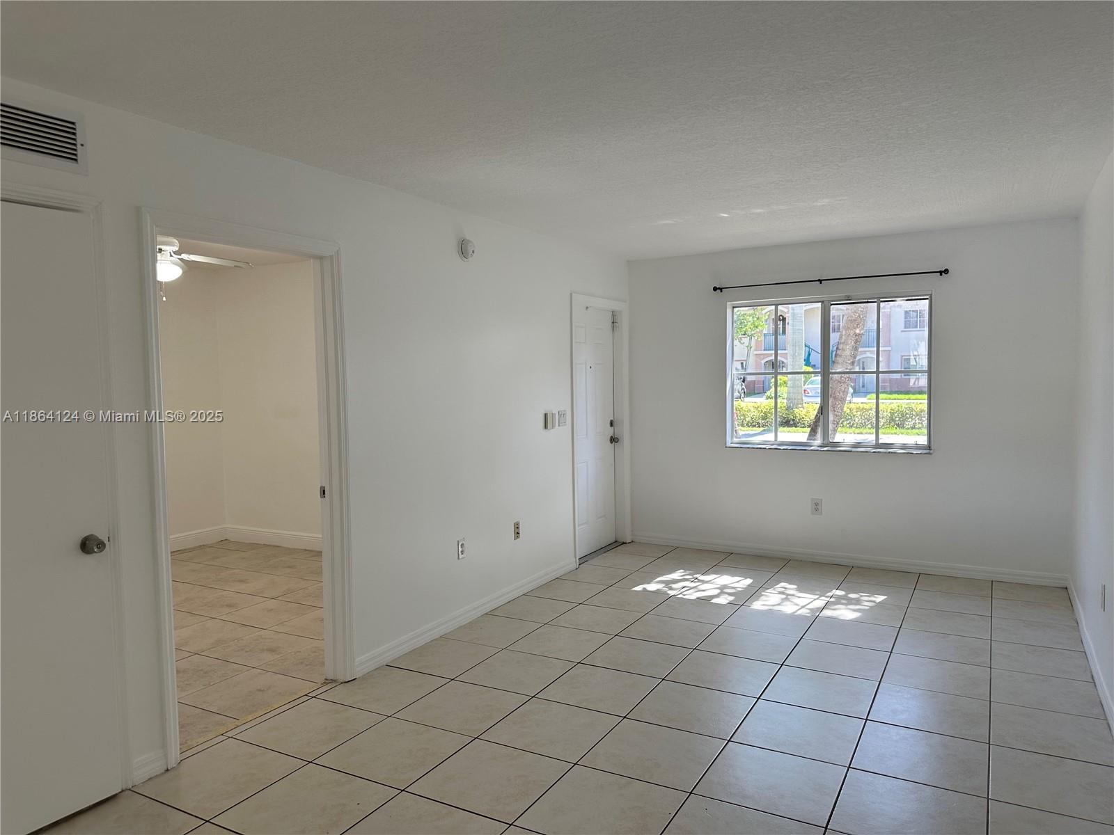 2910 Southeast 13th Avenue, Unit 10250 Homestead, FL 33035 - Photo 4 of 23 a view of an empty room with window