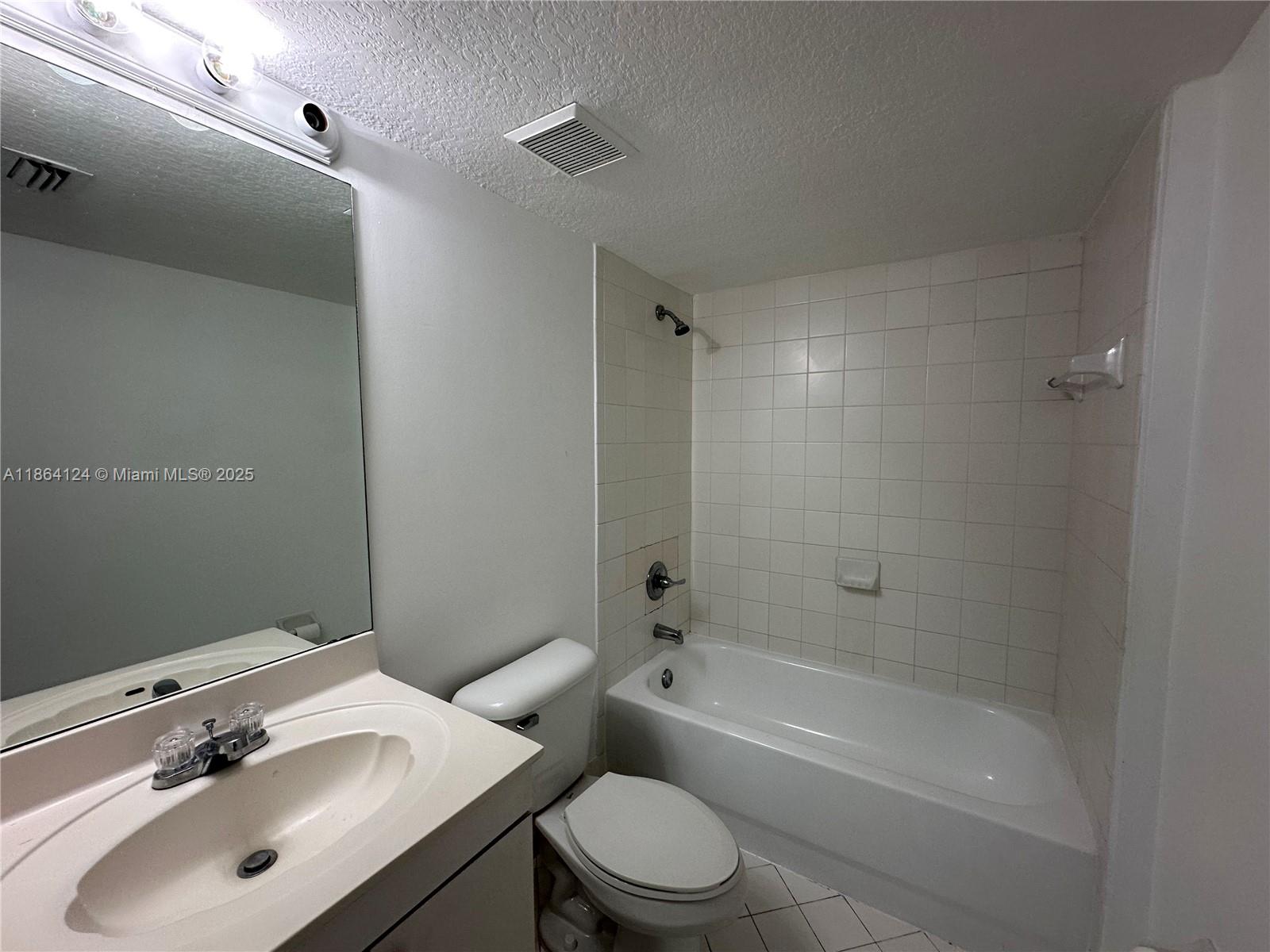 2910 Southeast 13th Avenue, Unit 10250 Homestead, FL 33035 - Photo 7 of 23 a bathroom with a sink toilet and shower