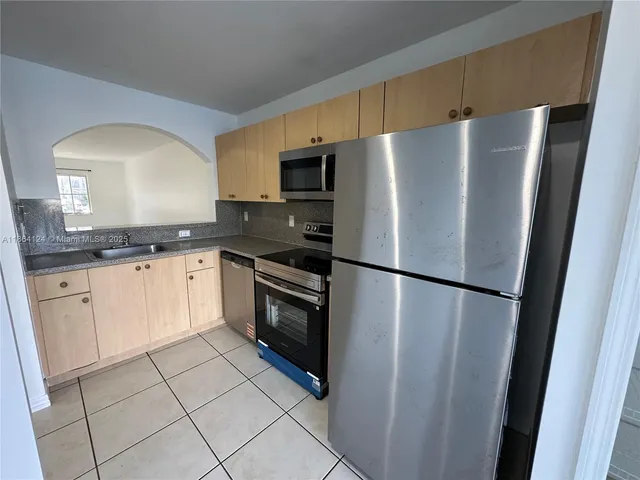 a white refrigerator freezer sitting inside of a kitchen