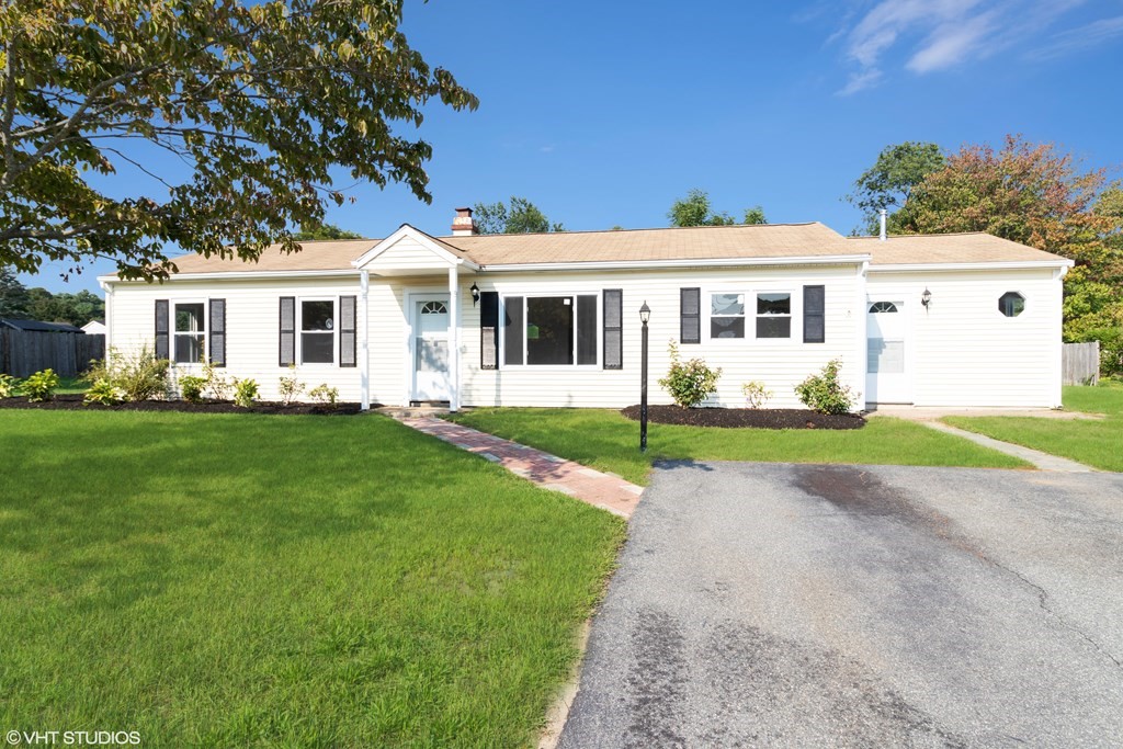 a front view of house with yard and green space