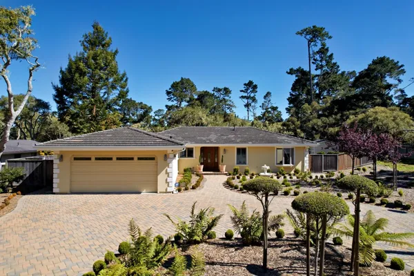 a front view of a house with garden