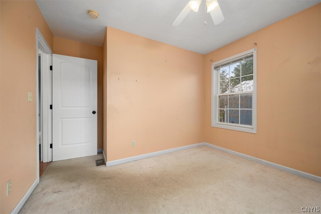1322 Sawmill Road Sangerfield, NY 13480 - Photo 34 of 50 Natural light pours through a multi-pane window in this carpeted bedroom.