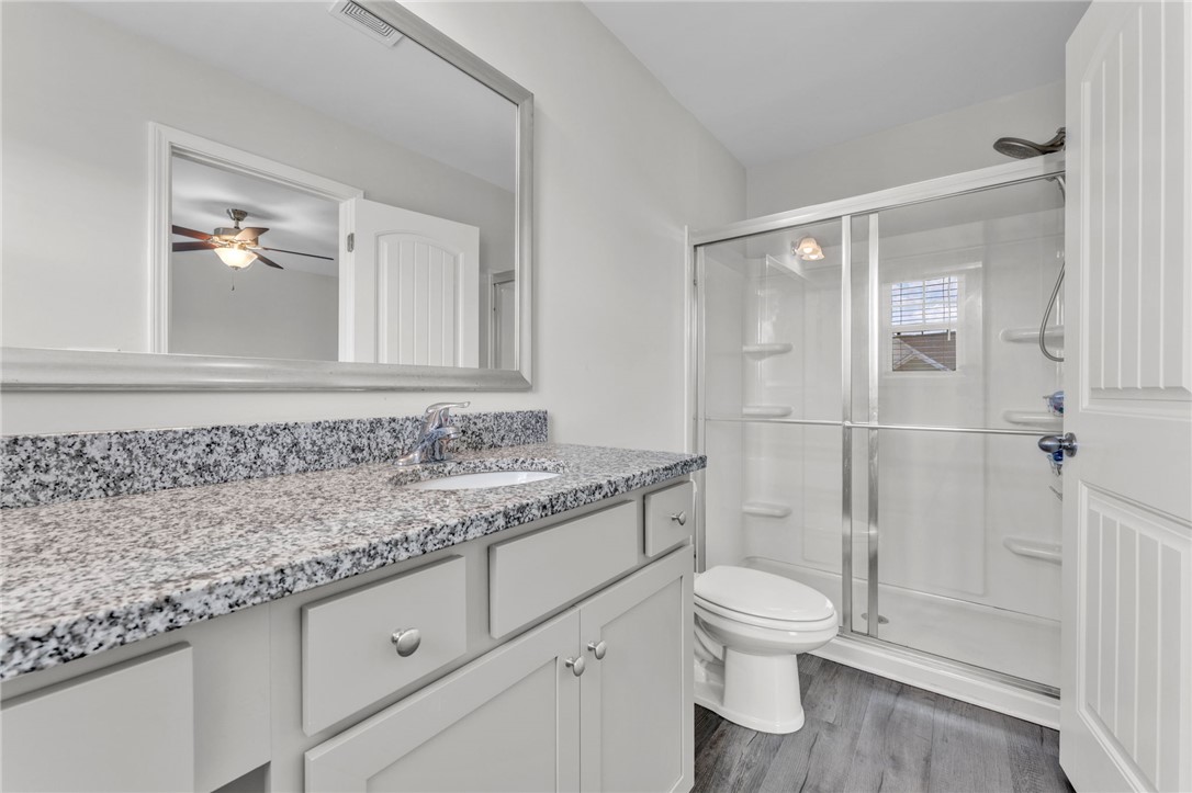 208 Samuel Street Pendleton, SC 29670 - Photo 14 of 32 Step into a well-appointed bathroom featuring granite counters and a practical walk-in shower.