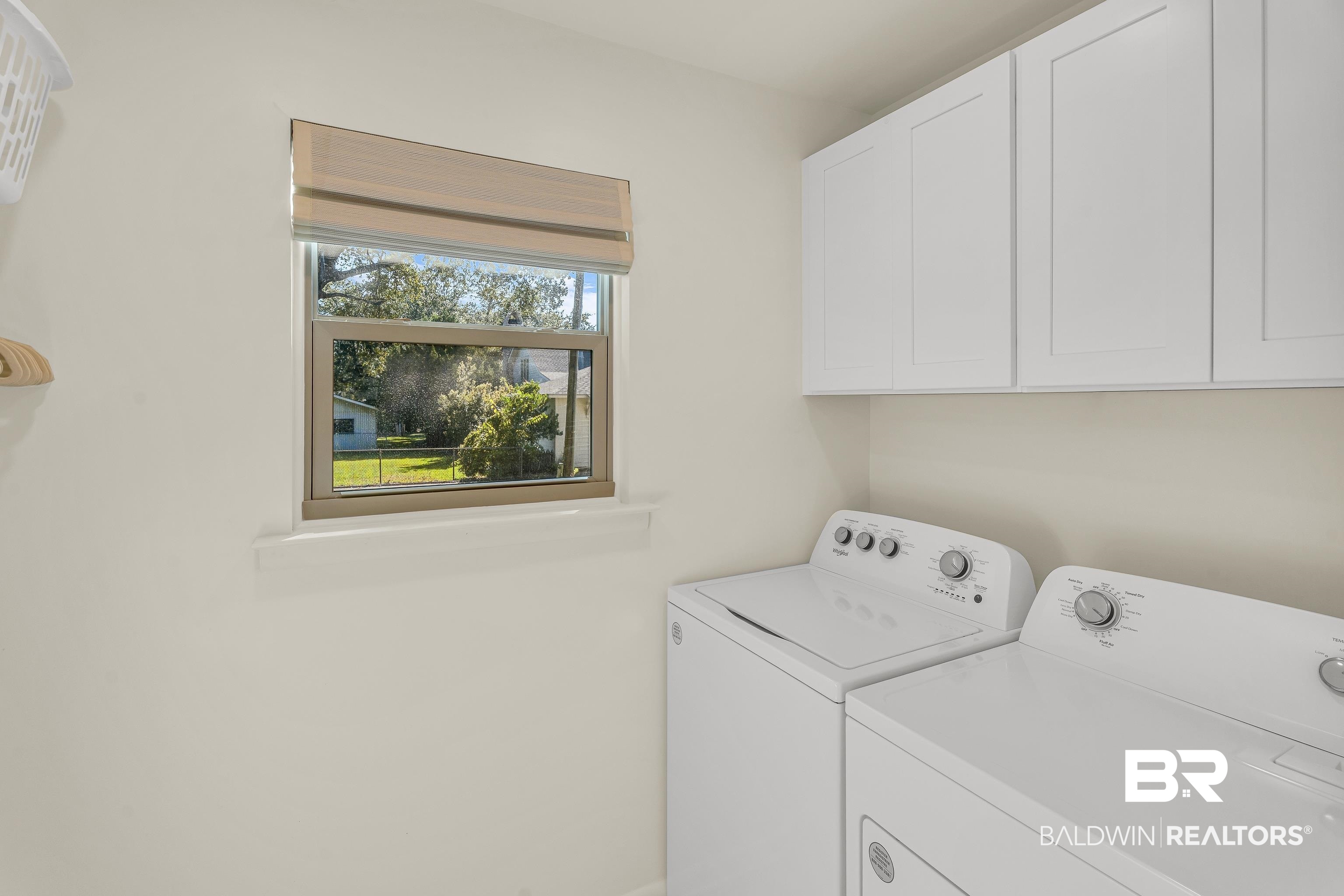 357 Azalea Street Fairhope, AL 36532 - Photo 12 of 22 Washroom featuring washing machine and clothes dryer and cabinet space