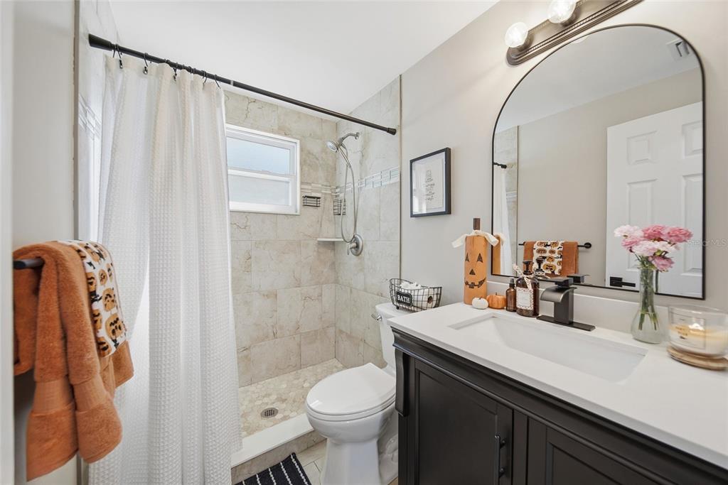 3744 Carron Street New Port Richey, FL 34652 - Photo 12 of 28 a bathroom with a sink a toilet and shower