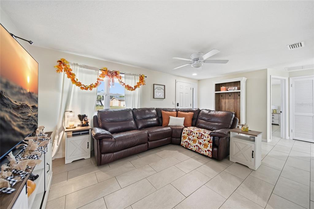 3744 Carron Street New Port Richey, FL 34652 - Photo 13 of 28 a living room with furniture and a flat screen tv
