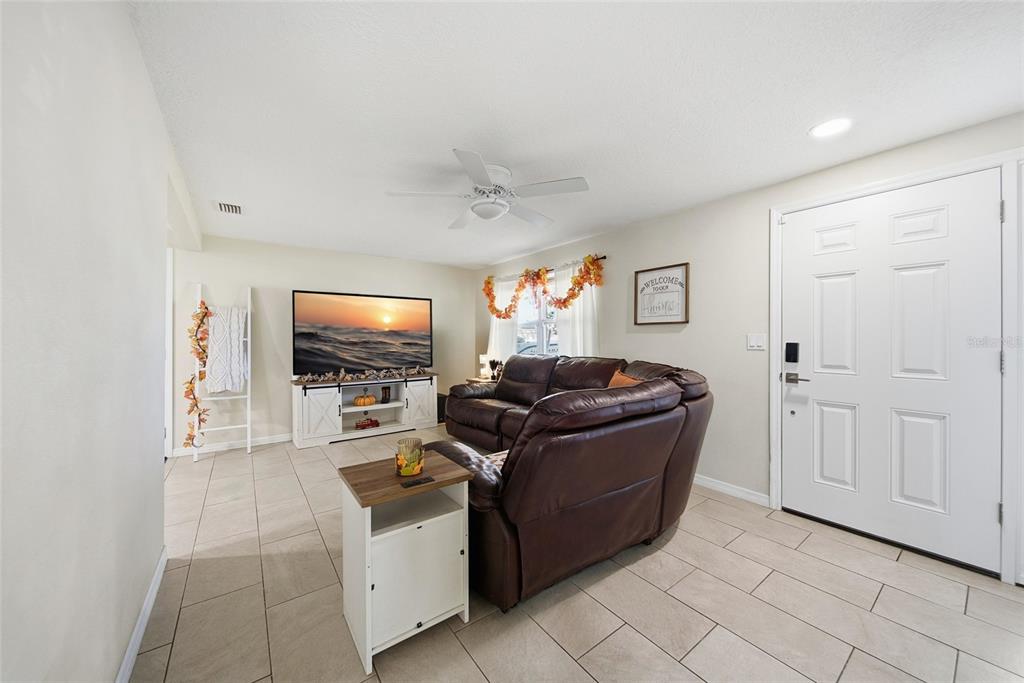 3744 Carron Street New Port Richey, FL 34652 - Photo 14 of 28 a living room with furniture and a flat screen tv