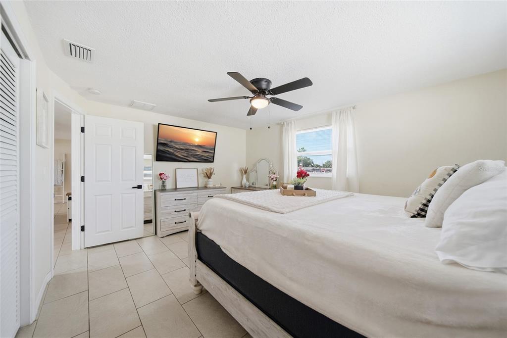 3744 Carron Street New Port Richey, FL 34652 - Photo 16 of 28 a bed room with a bed and a flat tv screen