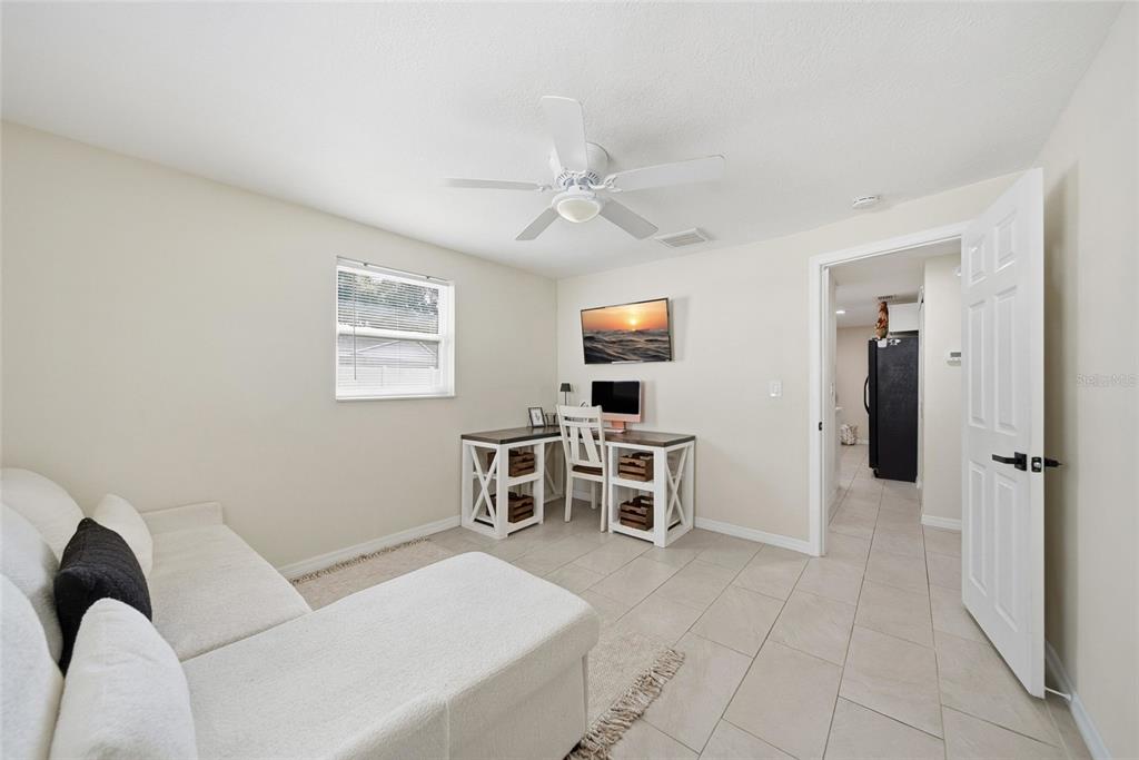 3744 Carron Street New Port Richey, FL 34652 - Photo 17 of 28 a living room with furniture a ceiling fan and a window
