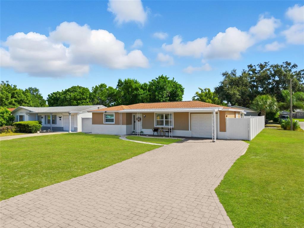 3744 Carron Street New Port Richey, FL 34652 - Photo 5 of 28 a front view of a house with a garden