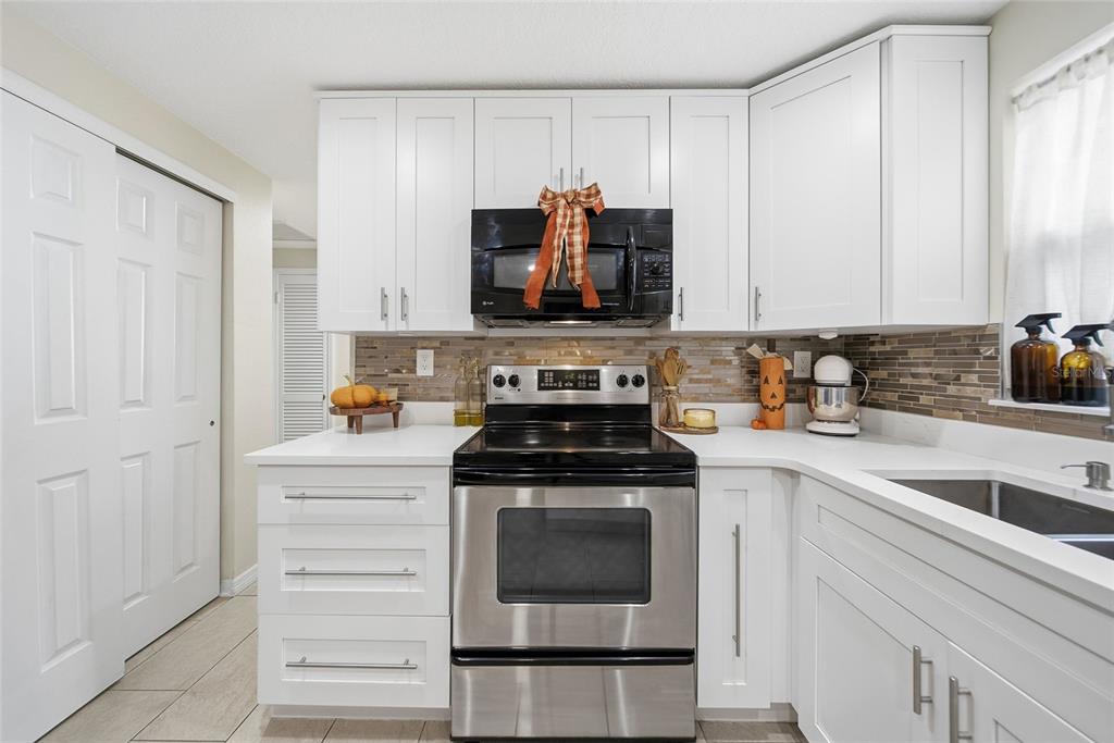 3744 Carron Street New Port Richey, FL 34652 - Photo 9 of 28 a kitchen with a stove and a sink