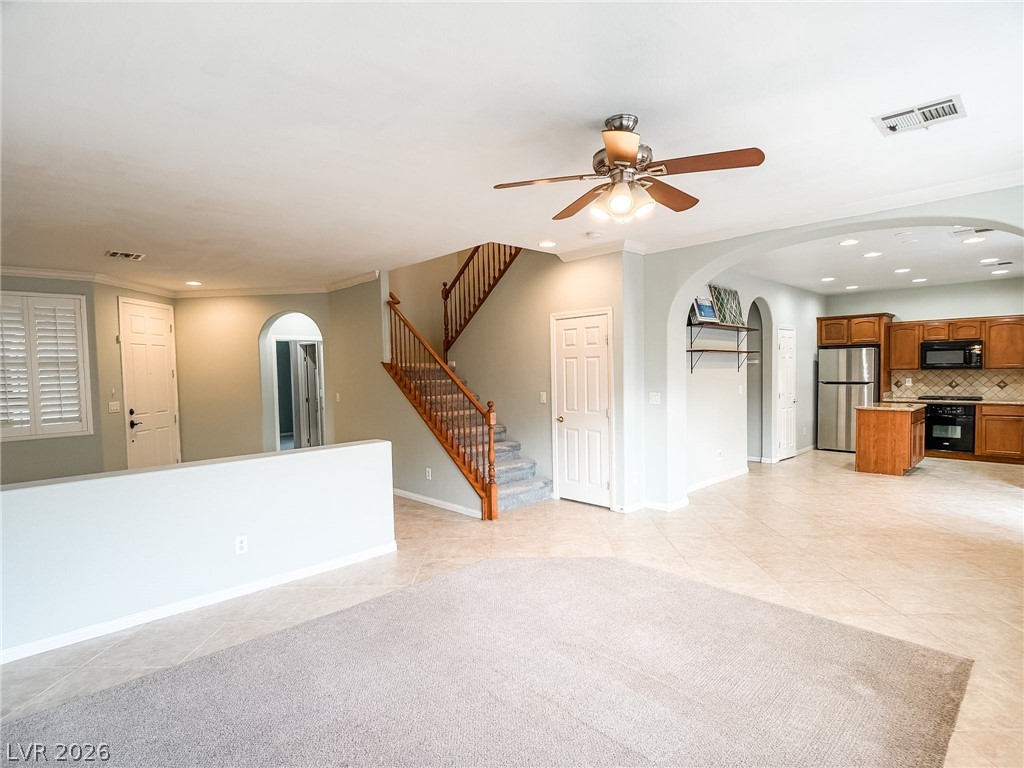 8683 Moreno Mountain Avenue Las Vegas, NV 89178 - Photo 5 of 26 An inviting open-concept living area flows into a functional kitchen, offering versatile space for daily life.