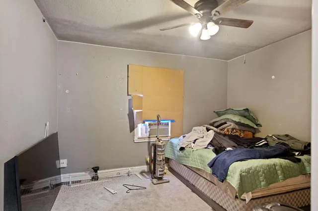 a bedroom with bed and a window