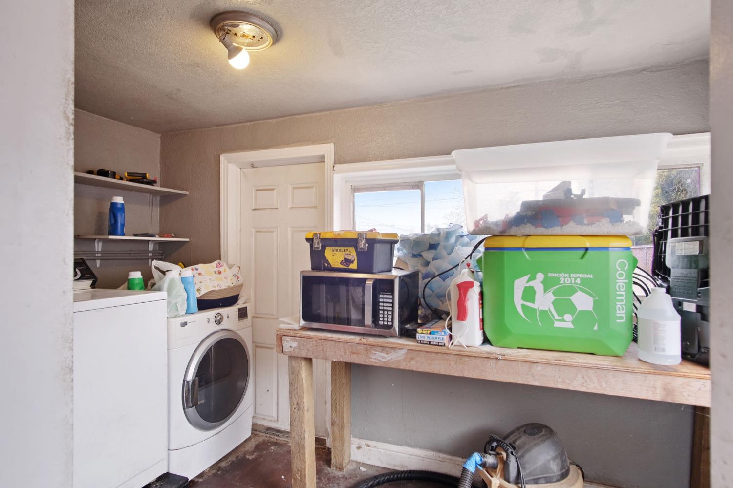 1225 Eugene Avenue Modesto, CA 95351 - Photo 13 of 39 a room with a refrigerator a washer and dryer