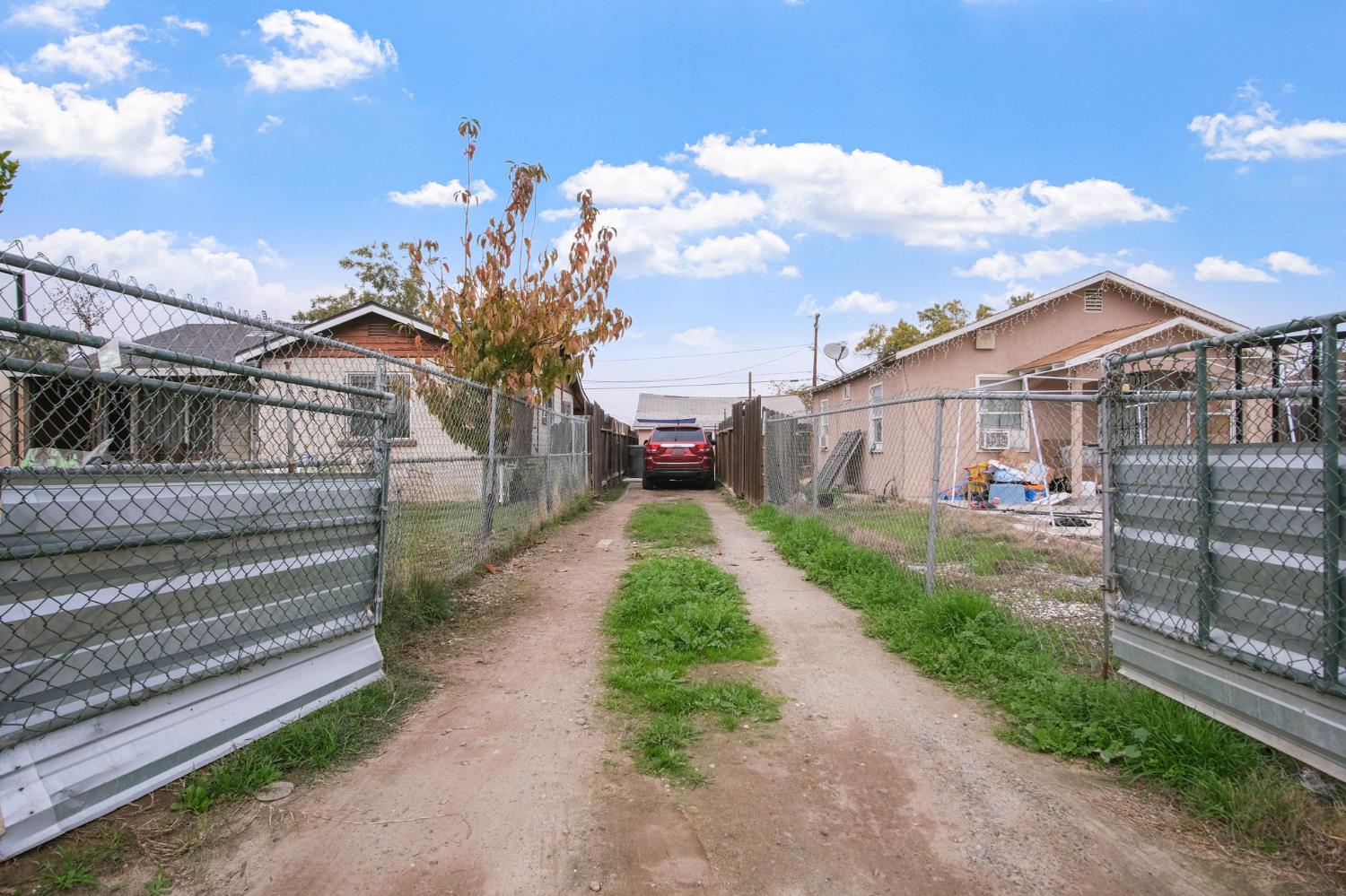 1225 Eugene Avenue Modesto, CA 95351 - Photo 17 of 39 a view of a house with a small yard and large tree