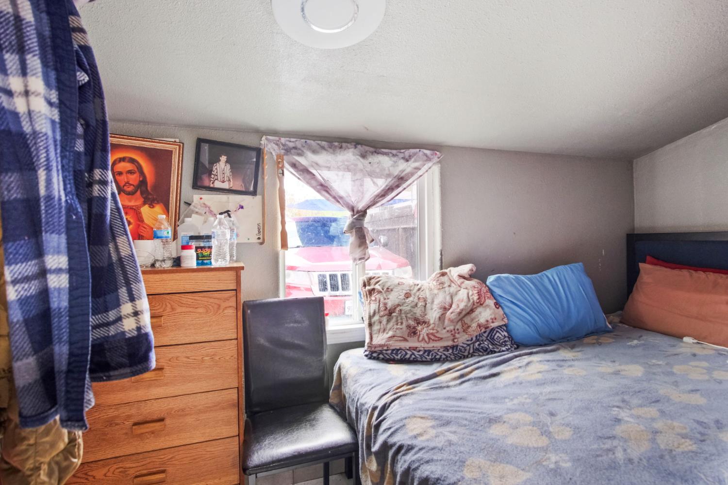 1225 Eugene Avenue Modesto, CA 95351 - Photo 19 of 39 a bedroom with a bed and wooden floor