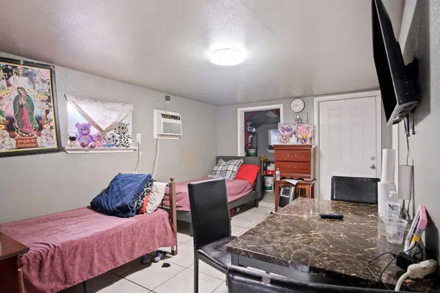 a bedroom with a bed and flat screen tv