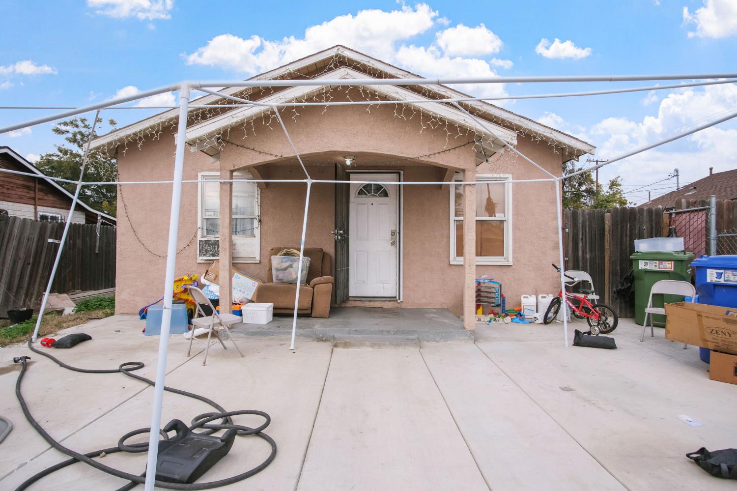1225 Eugene Avenue Modesto, CA 95351 - Photo 2 of 39 a view of a patio with table and chairs and potted plants