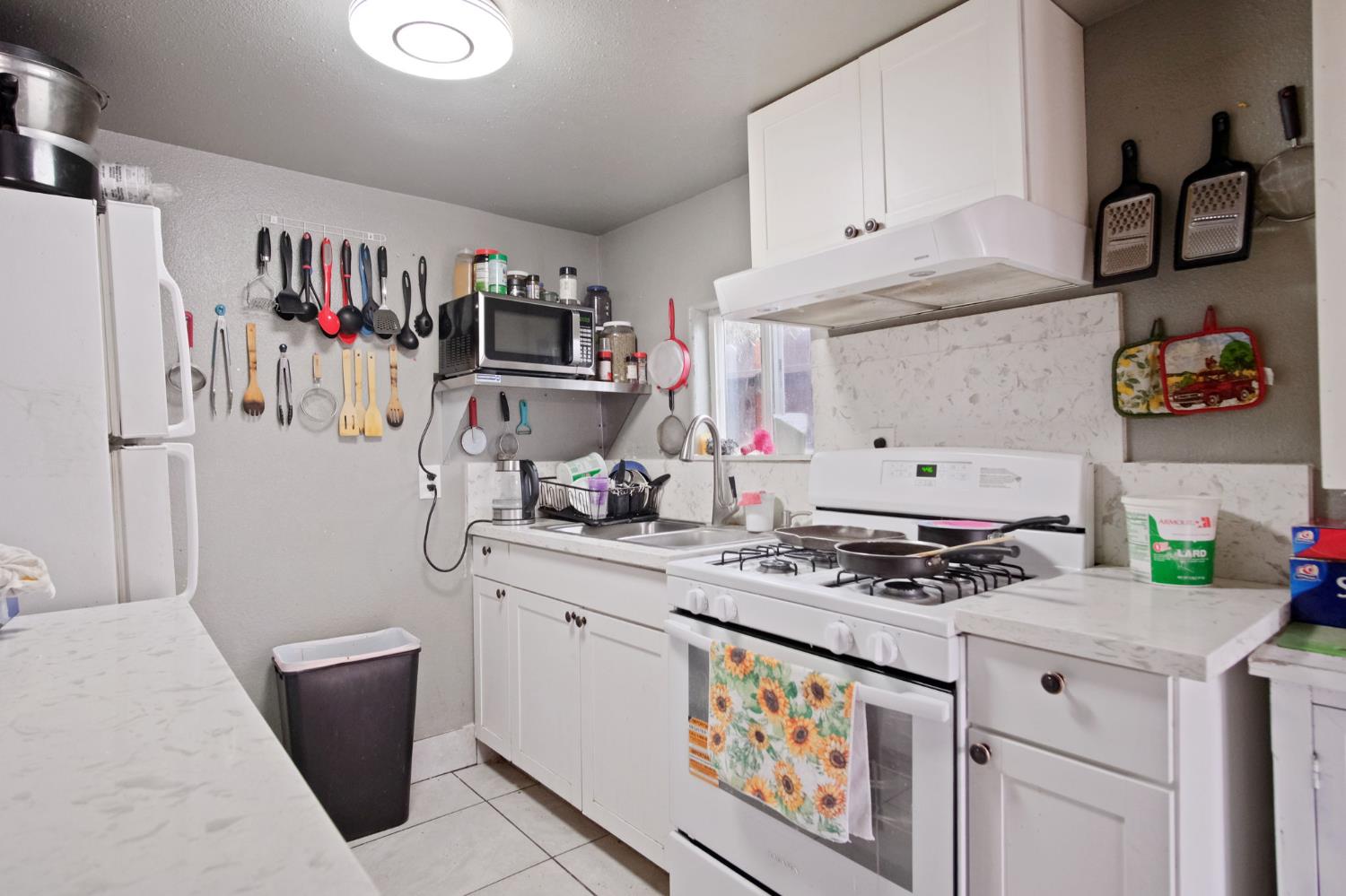 1225 Eugene Avenue Modesto, CA 95351 - Photo 27 of 39 a kitchen with stainless steel appliances a white cabinets and a stove