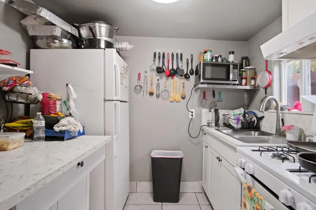 a kitchen with a refrigerator and a stove