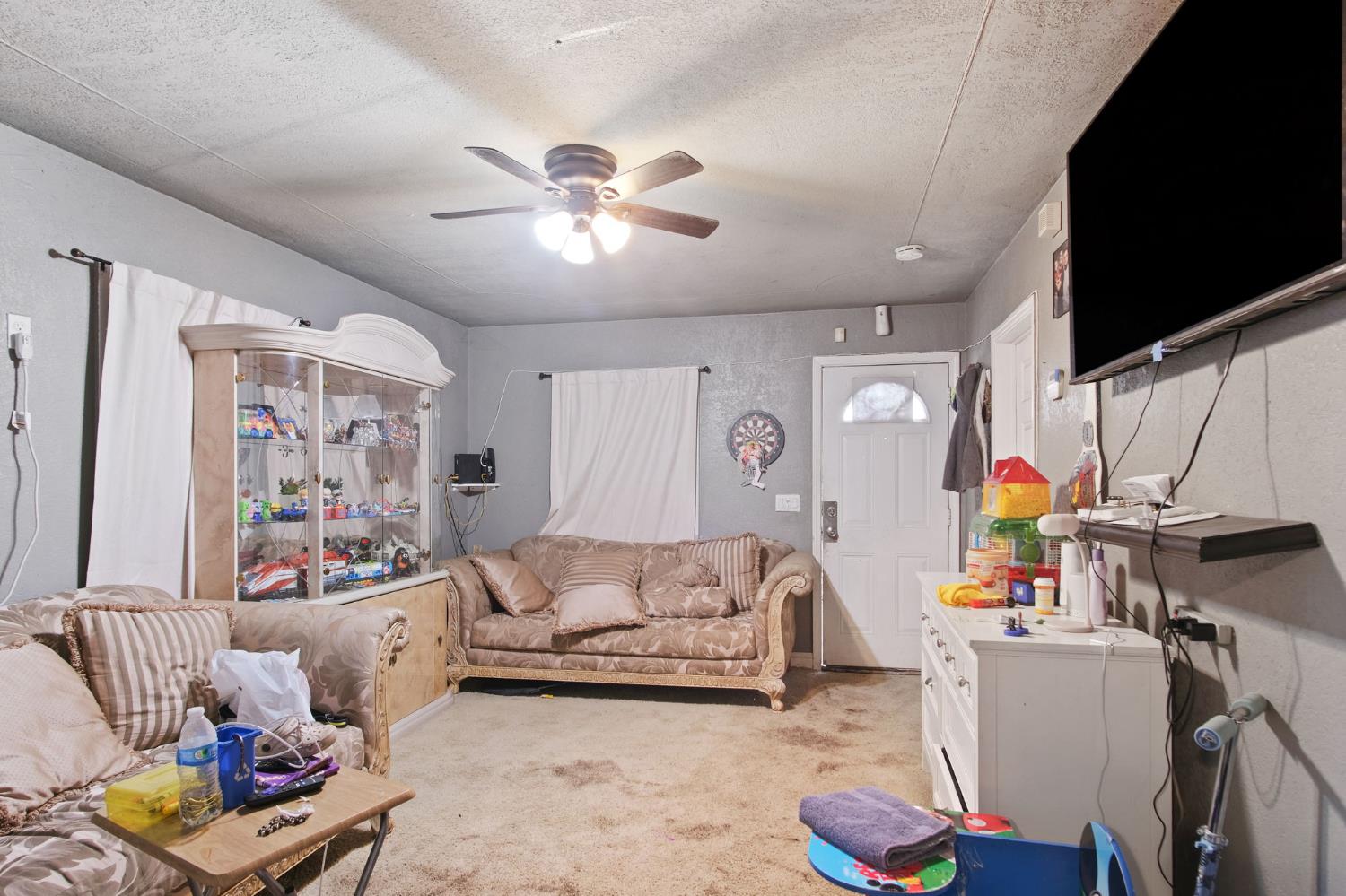 1225 Eugene Avenue Modesto, CA 95351 - Photo 6 of 39 a living room with furniture and a flat screen tv