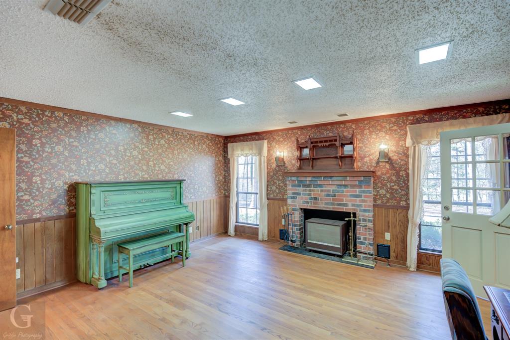 7105 Rodessa Ida Road Ida, LA 71044 - Photo 13 of 40 a living room with a fireplace wooden floor and a fireplace