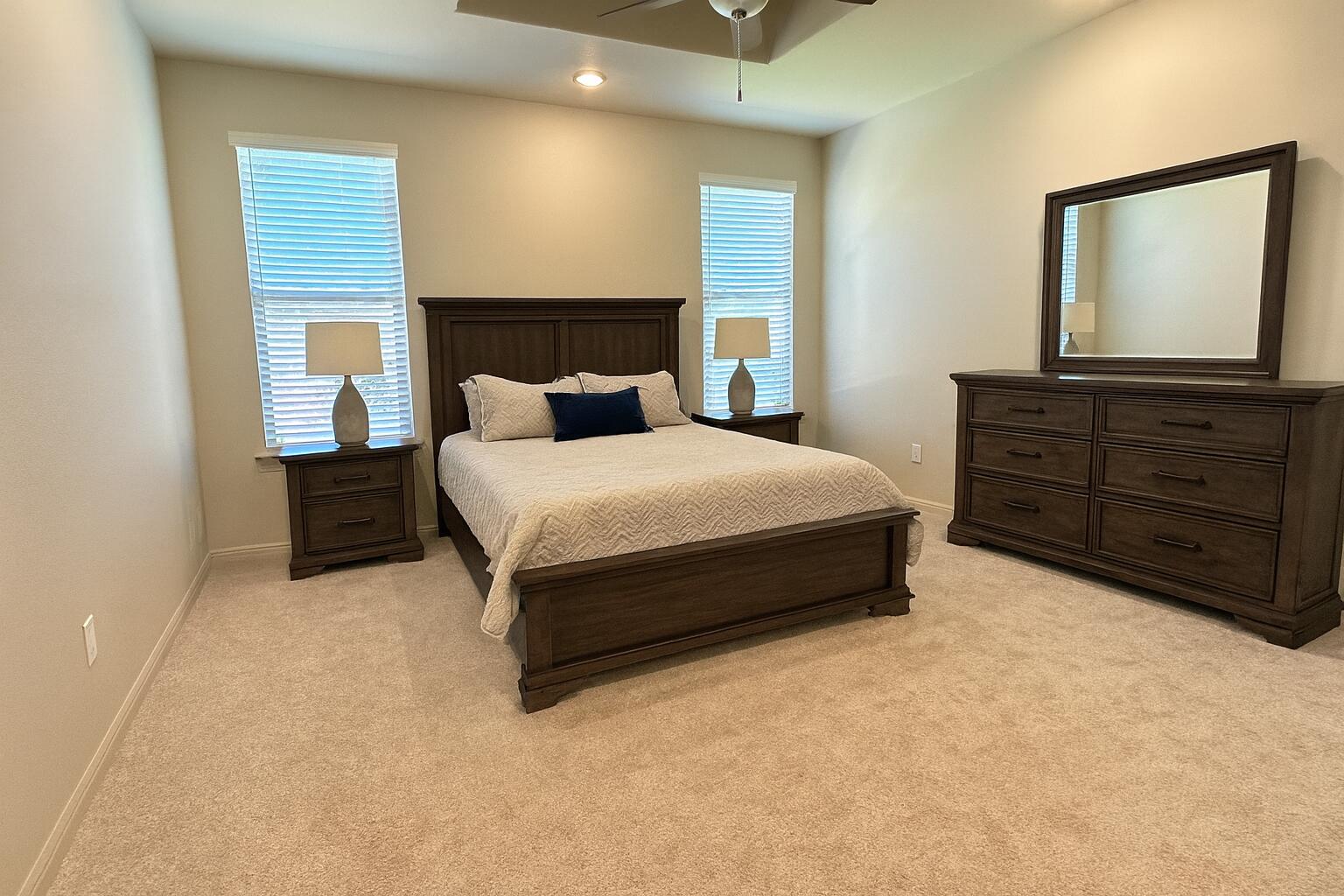 7504 87th Street Lubbock, TX 79424 - Photo 16 of 33 a bedroom with a bed and a dresser