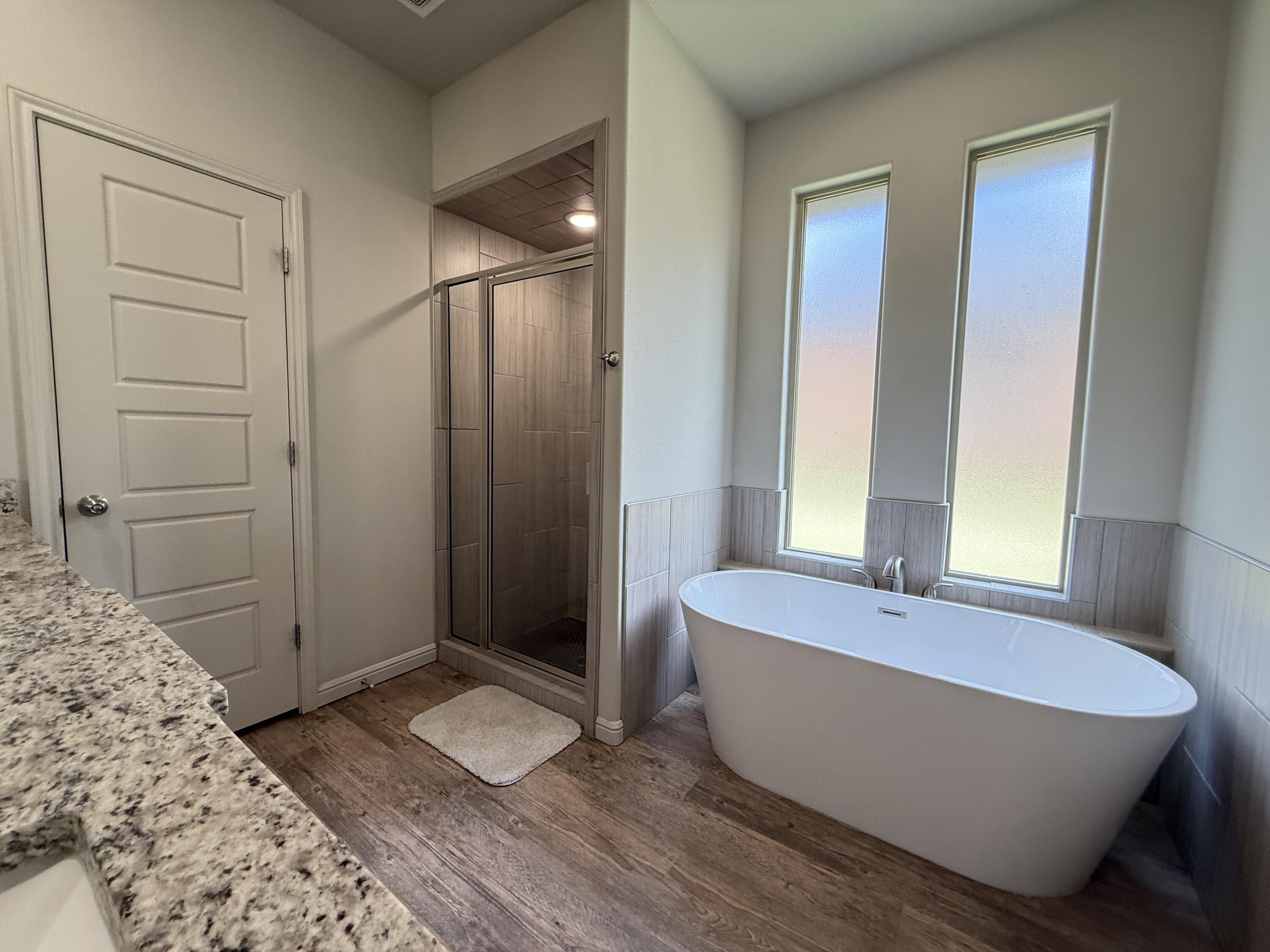7504 87th Street Lubbock, TX 79424 - Photo 20 of 33 a bathroom with a tub and shower