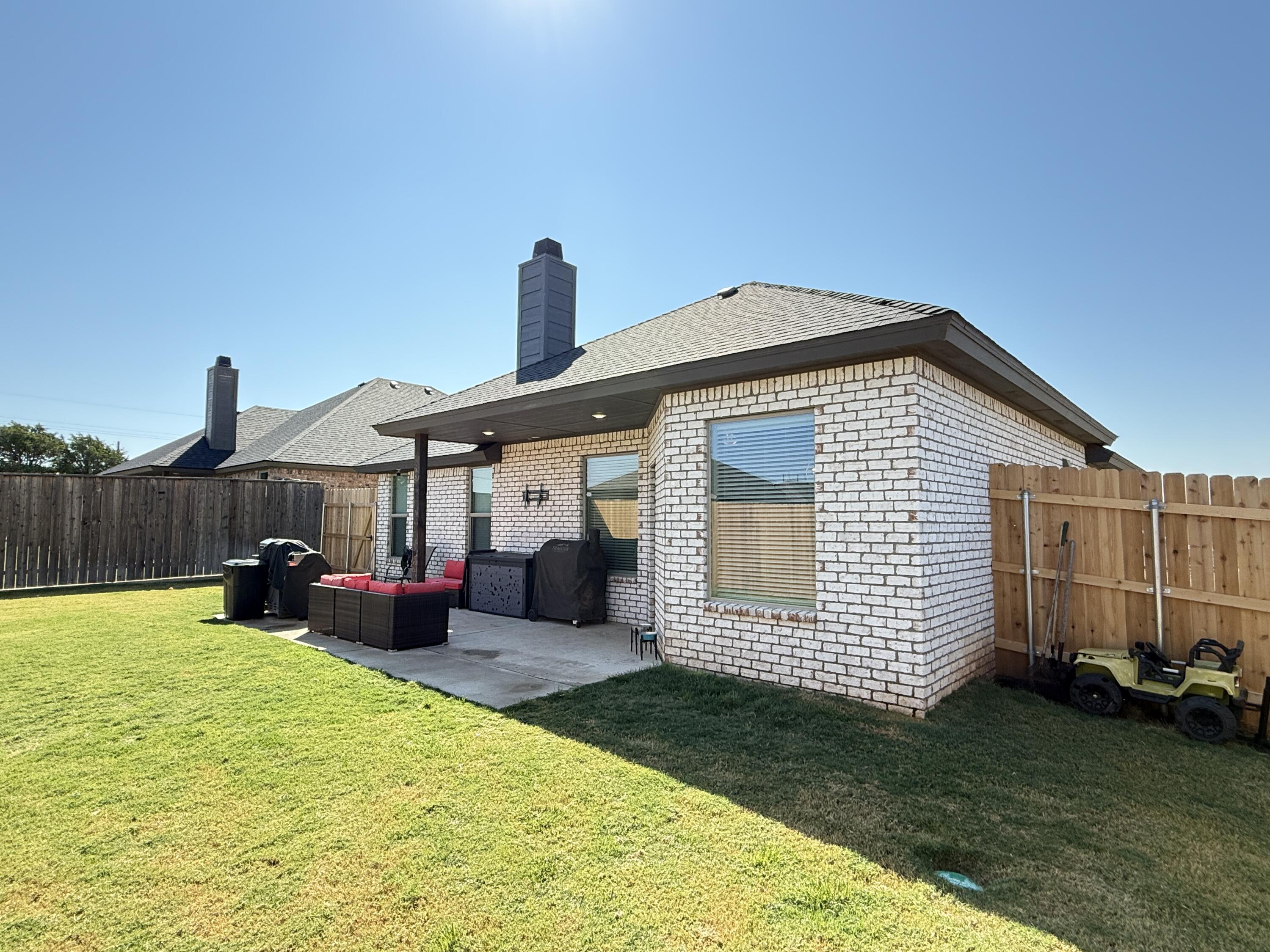 7504 87th Street Lubbock, TX 79424 - Photo 28 of 33 a front view of a house with garden