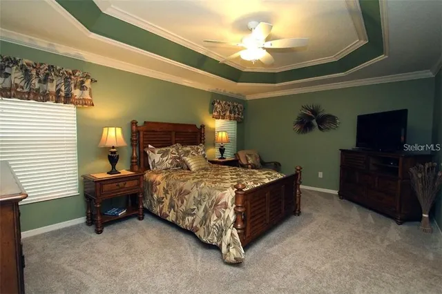 a bedroom with a bed and a television