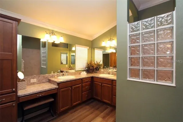 a bathroom with a sink a vanity and a large mirror