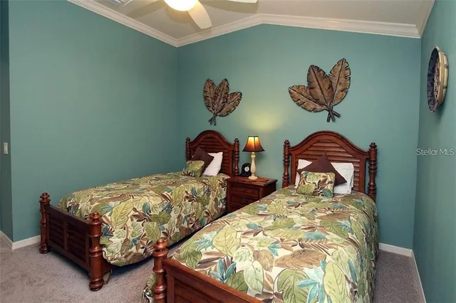 a bedroom with two beds and a painting on the wall