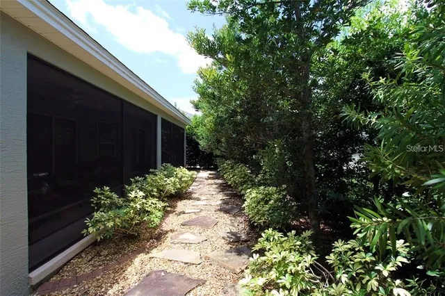 a front view of a house with a garden and yard