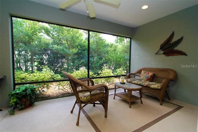 a living room with furniture and a floor to ceiling window